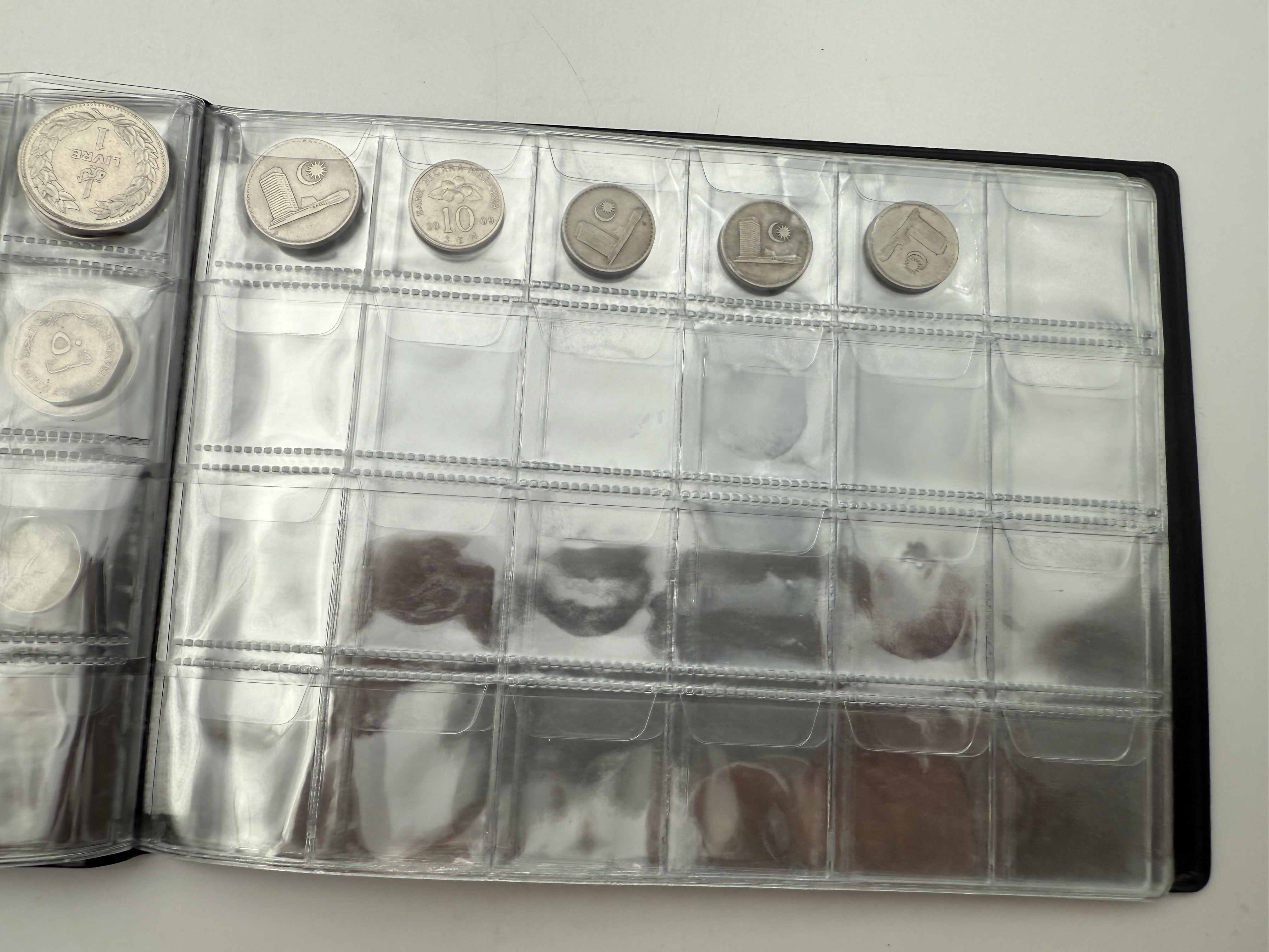 Iran / Lebanon / Malaysia / United Arab Emirates - a collection of several dozents coins arranged in a special coin ... - 1 9