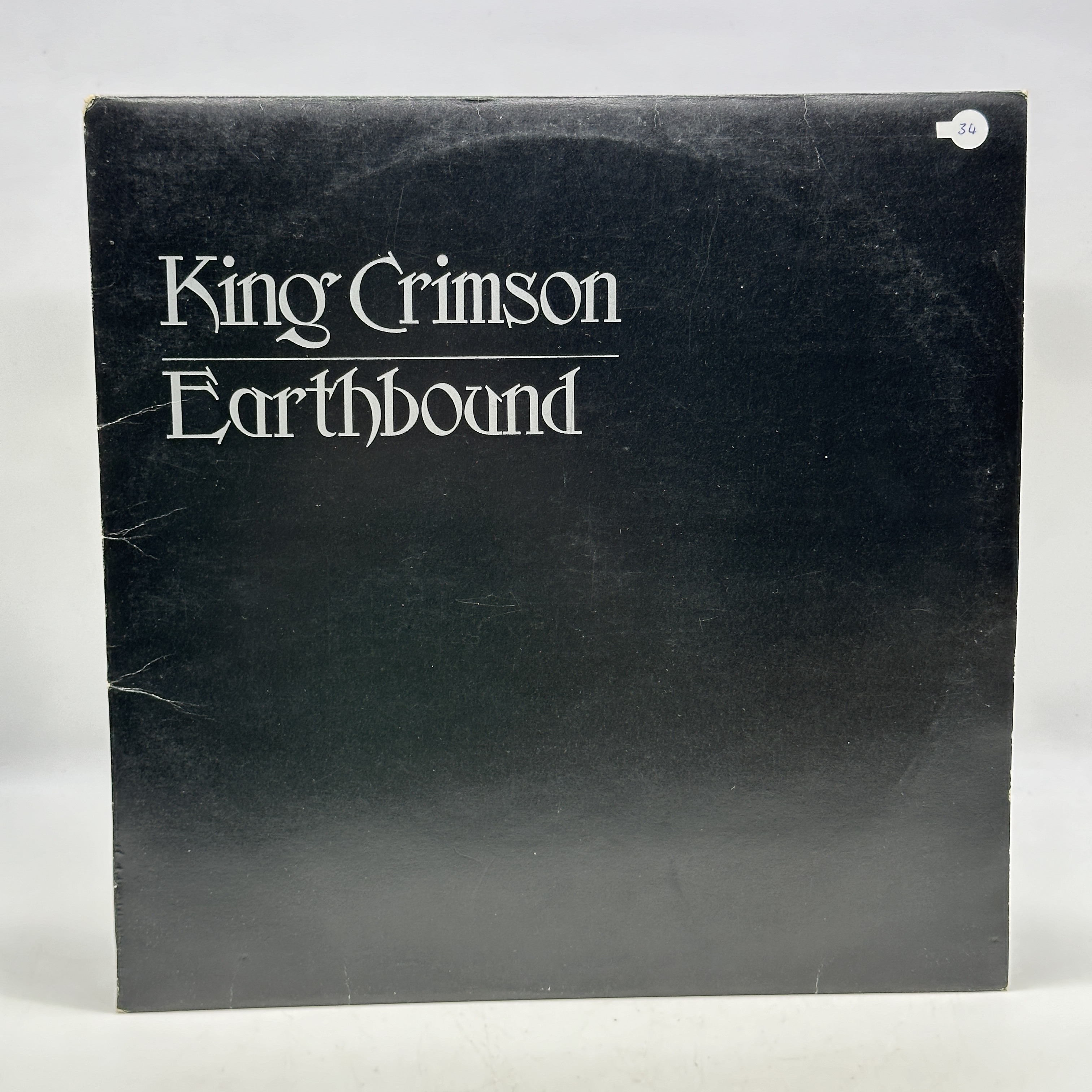 A 12 inch vinyl album by King Crimson - Earthbound, cover is in good condition, inner cover has a rip, no scratches - 1 0