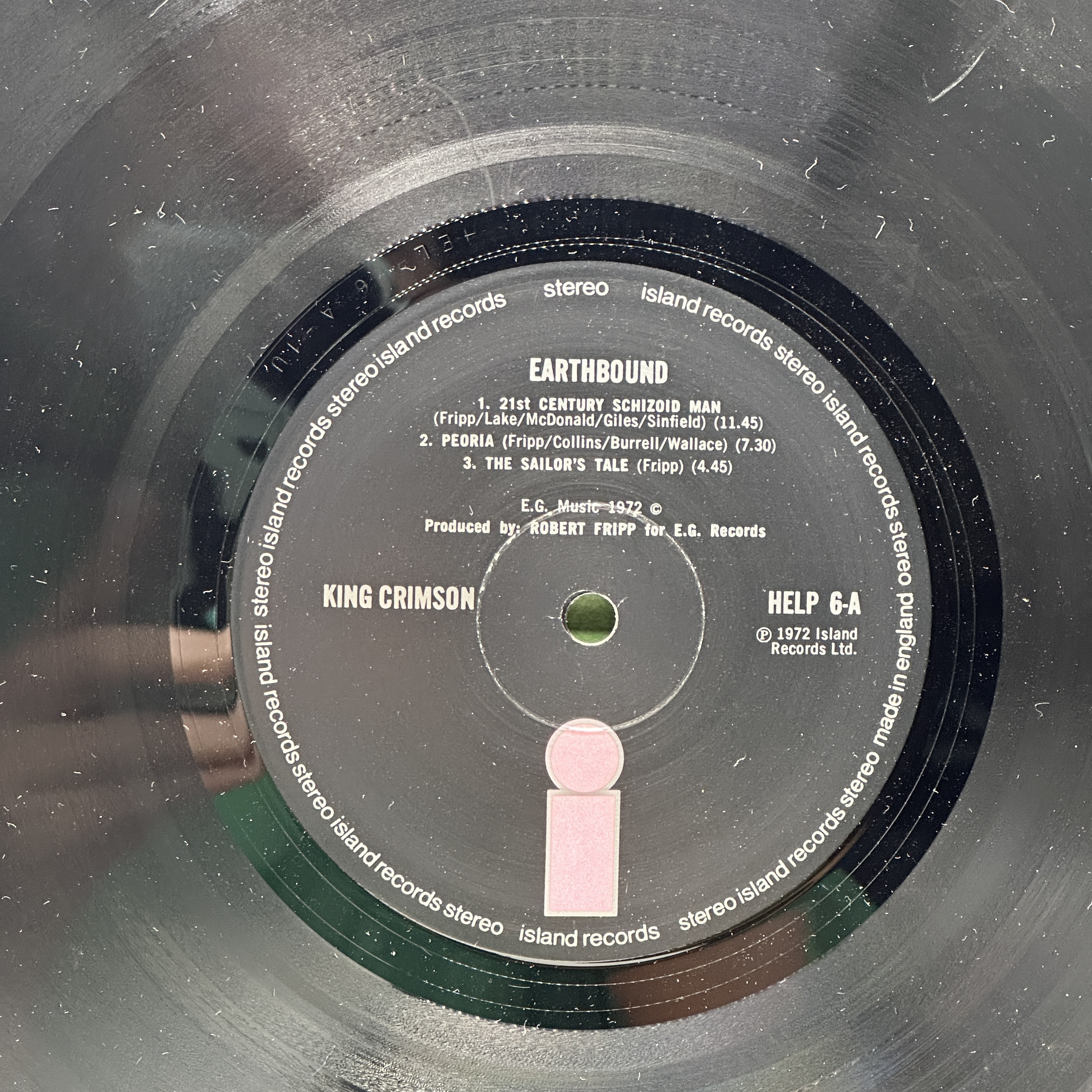 A 12 inch vinyl album by King Crimson - Earthbound, cover is in good condition, inner cover has a rip, no scratches - 1 2