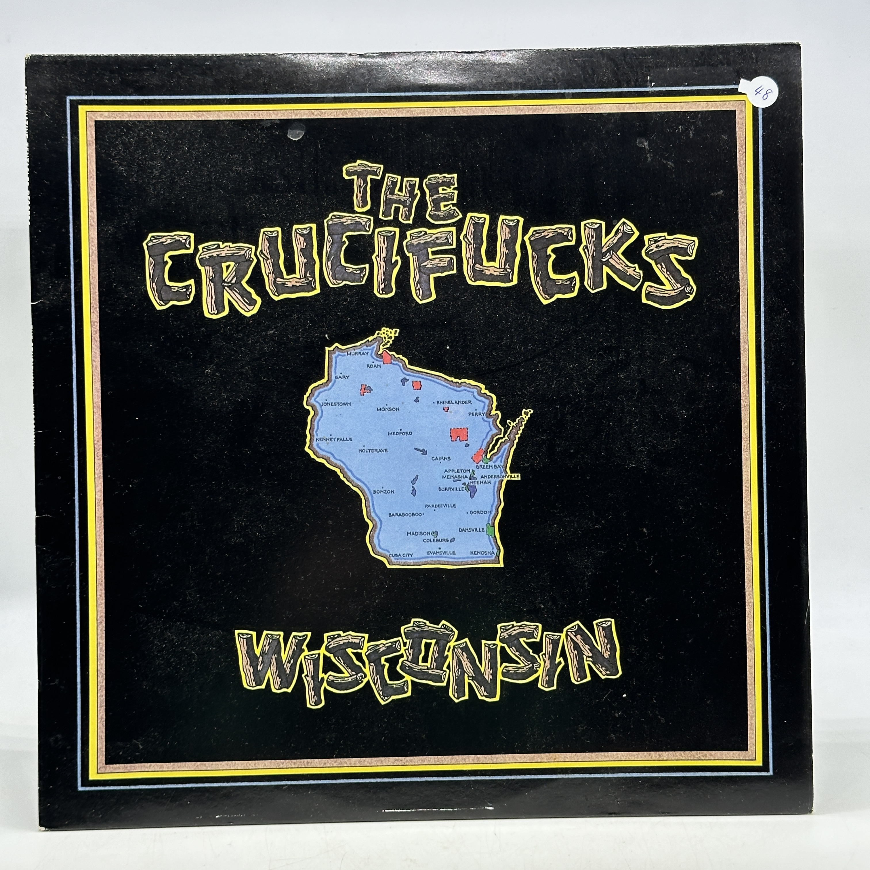 A 12 inch vinyl album by The Crucifucks - Wisconsin, cover in good order, vinyl is bright yellow and in good condition - 1 0