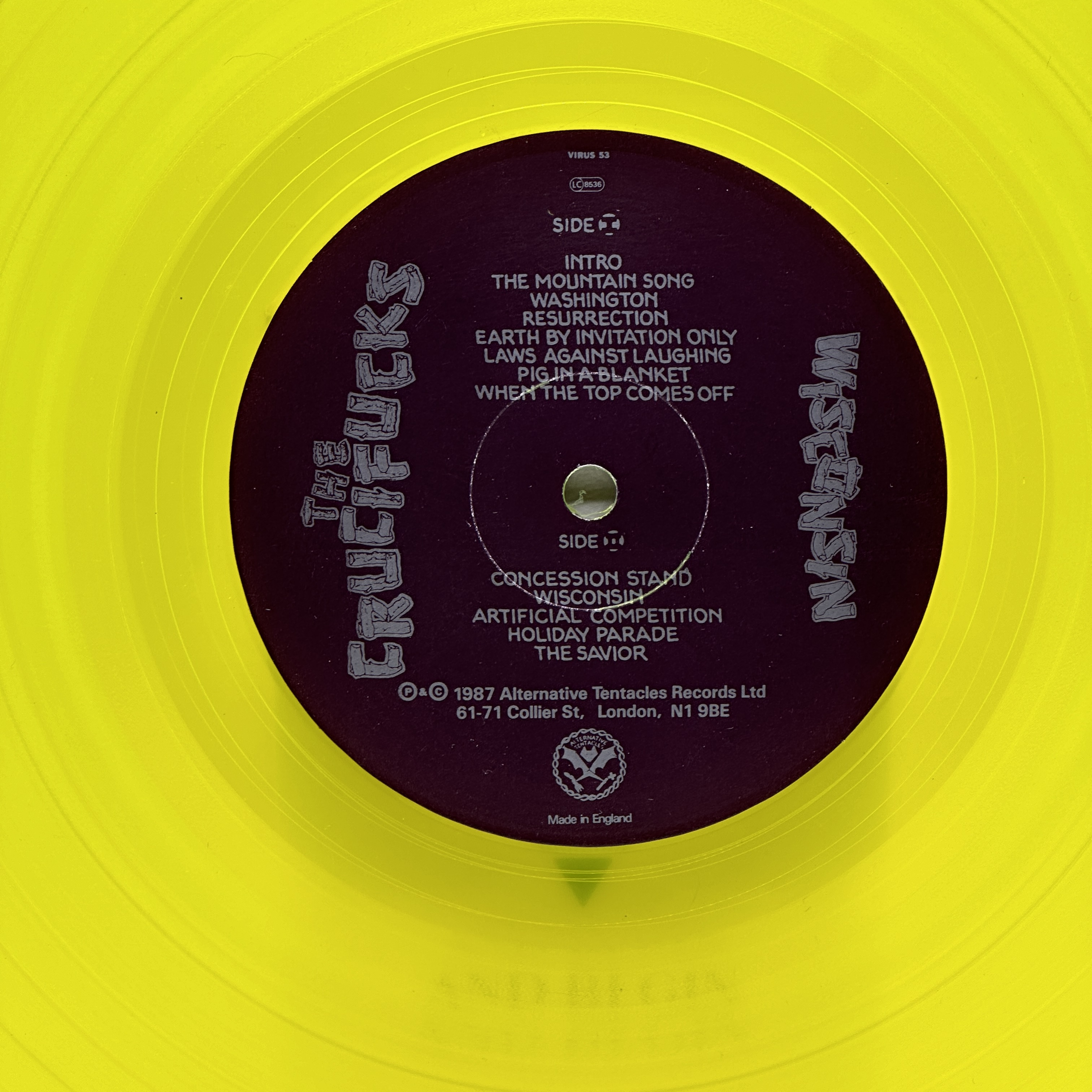 A 12 inch vinyl album by The Crucifucks - Wisconsin, cover in good order, vinyl is bright yellow and in good condition - 1 3