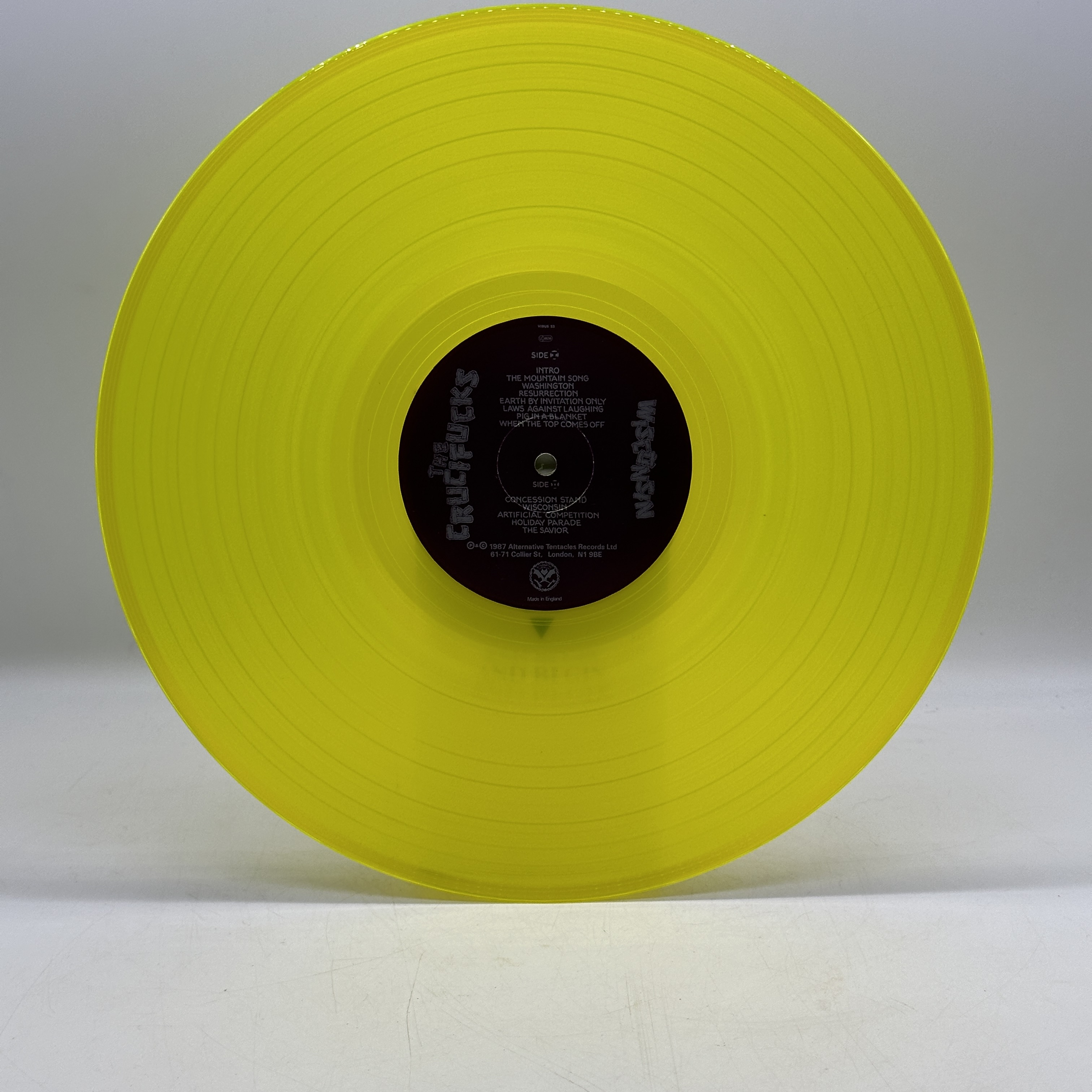 A 12 inch vinyl album by The Crucifucks - Wisconsin, cover in good order, vinyl is bright yellow and in good condition - 1 2