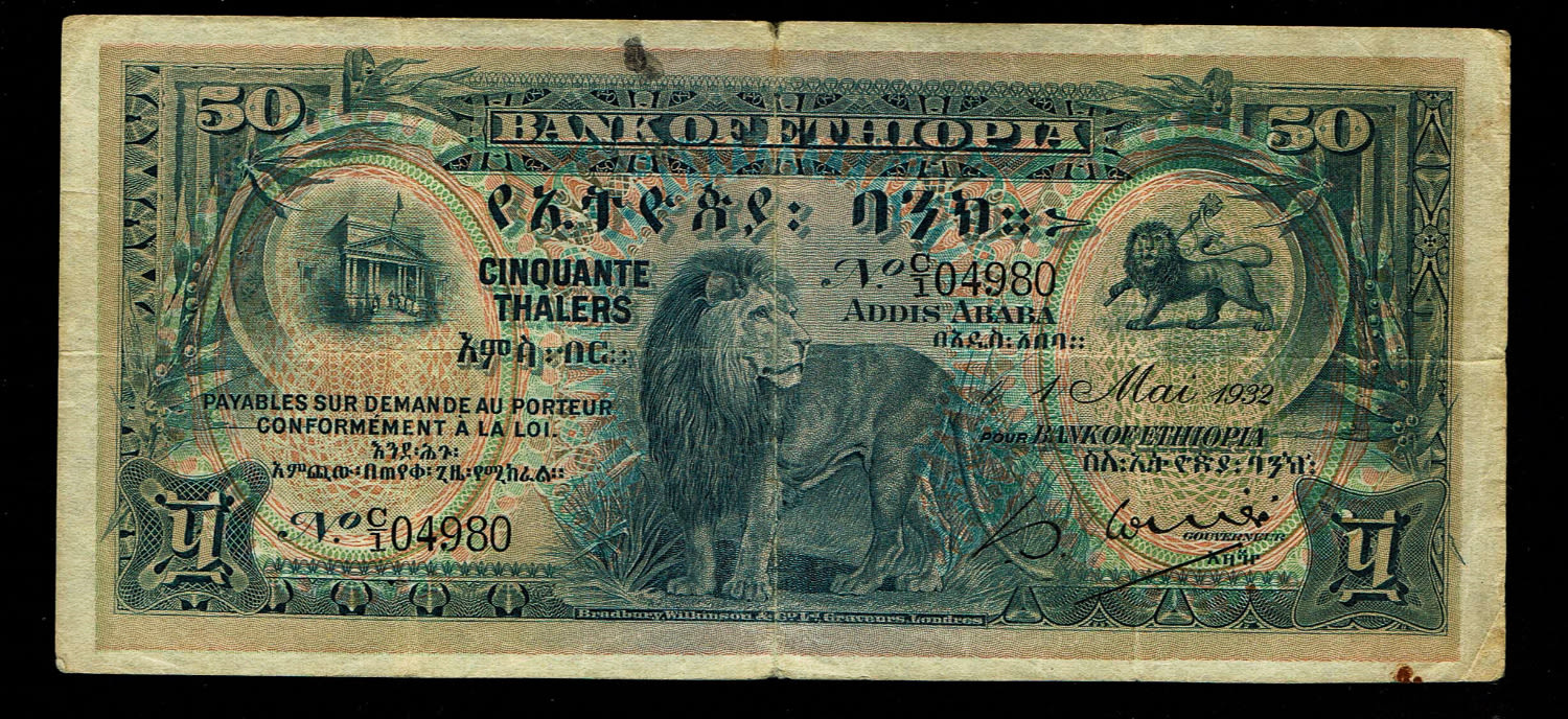 Ethiopia - 50 Thalers 1932 - F-VF
Obverse
Lion at centre, arms at upper right, bank building ... - 1 0